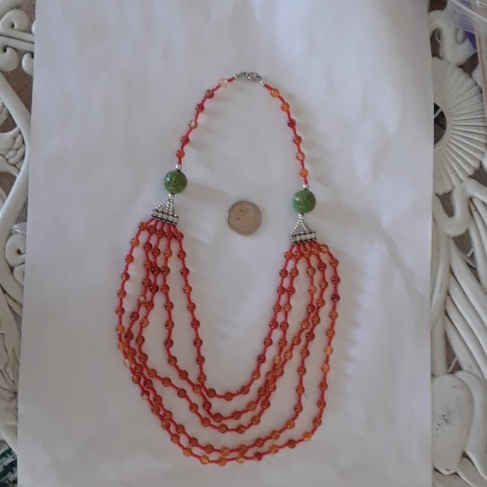 Vintage layered plastic orange bead necklace.